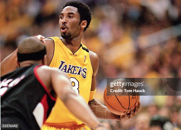 Kobe Bryant of the Los Angeles Lakers looks for an open man during Game 7 of the Western Conference Finals against the Portland Trail Blazers at...