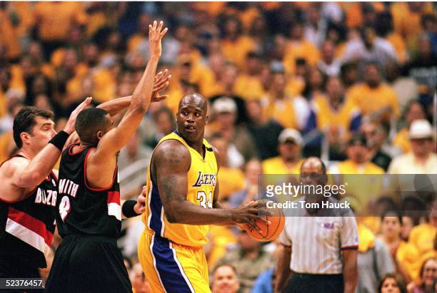 Shaquille O'Neal of the Los Angeles Lakers looks to move against Arvydas Sabonis and Steve Smith of the Portland Trail Blazers during Game 7 of the...