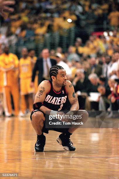 Damon Stoudamire of the Portland Trail Blazers kneels on the court during Game 7 of the Western Conference Finals against the Los Angeles Lakers at...