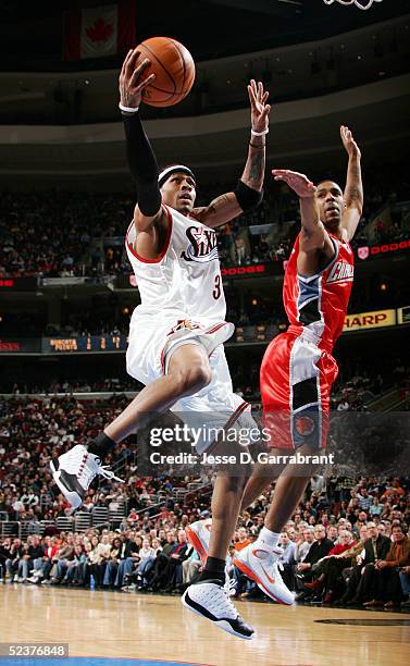 Allen Iverson of the Philadelphia 76ers lays one up against the defense of the Charlotte Bobcats on March 11, 2005 at the Wachovia Center in...