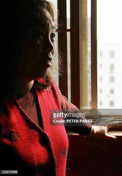 Beijing resident and SARS survivor Yang Yufeng at her home in the capital 05 March 2005. Two years after the SARS crisis, the epidemic is still a...