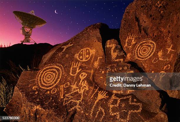 petroglyphs and radio telescope - cave paintings stockfoto's en -beelden