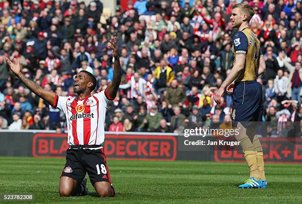 Jermain Defoe of Sunderland appeals for a penalty against Per Mertesacker of Arsenal during the Barclays Premier League match between Sunderland and...