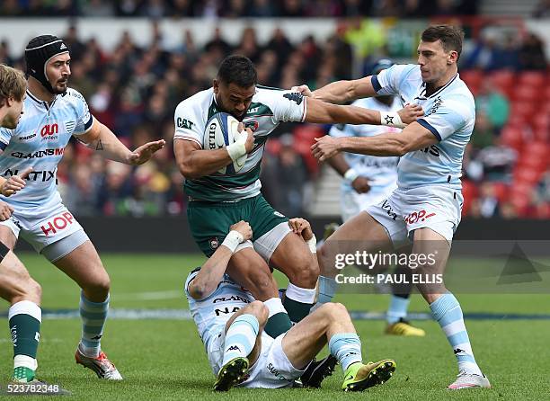 Leicester Tigers' New Zealand wing Telusa Veainu is tackled by Johannes Goosen of Racing Metro 92, and Juan Imhoff of Racing Metro 92 during the...