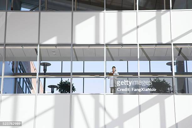 asian female doctor on the phone - elevated walkway stock pictures, royalty-free photos & images