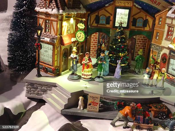 model victorian 'dickens' christmas village with miniature houses, people, winter-scene - victorian scrooge stock pictures, royalty-free photos & images