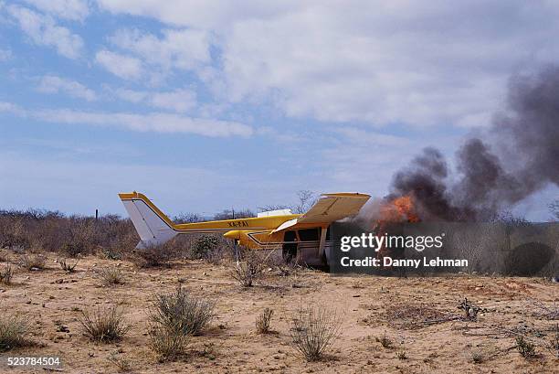 crashed airplane burning - plane crash stock pictures, royalty-free photos & images