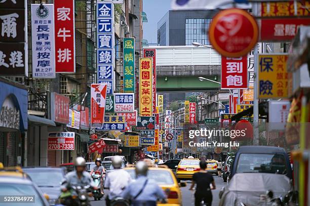 signs lining busy taipei street - taiwanese ethnicity stockfoto's en -beelden