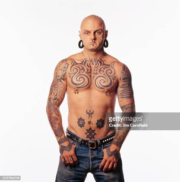 man with tattoos and body piercings - body piercings stock pictures, royalty-free photos & images