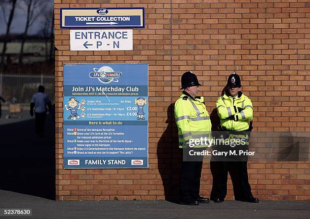 Amid threats of ground closure by Greater Manchester police two policeman patrol outside the JJB Stadium before the Coca-Cola Championship match...