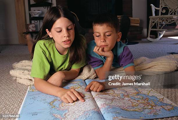 brother and sister looking at map - physical geography fotografías e imágenes de stock