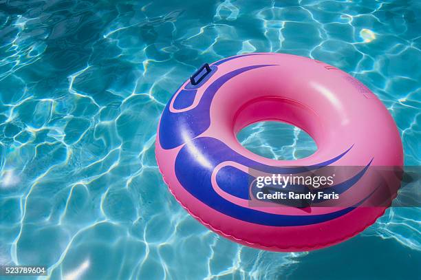 pink inner tube in a swimming pool - las vegas pool stock pictures, royalty-free photos & images