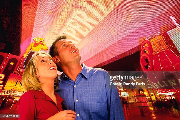 couple looking at las vegas lights - fremont street experience stockfoto's en -beelden