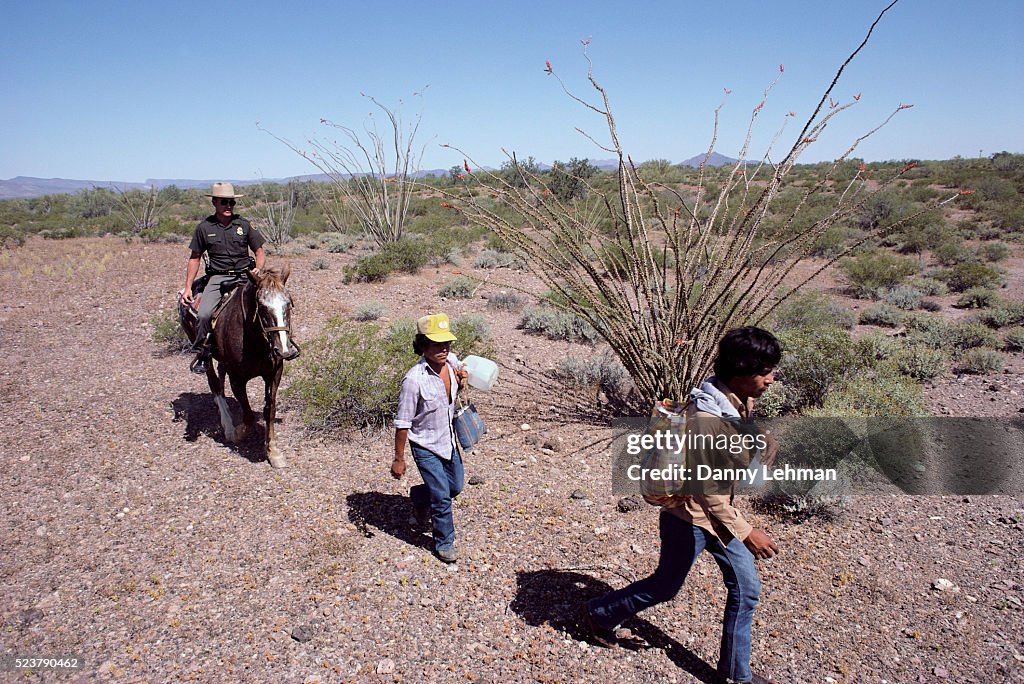 Border Patrol Officer with Two Mexican Emigrants