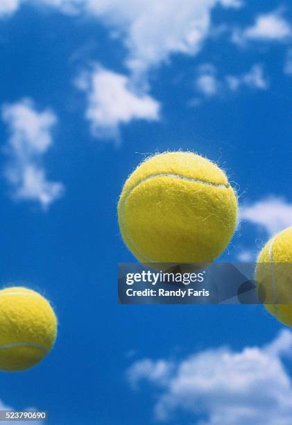 tennis balls up in the air - tennis ball stock pictures, royalty-free photos & images