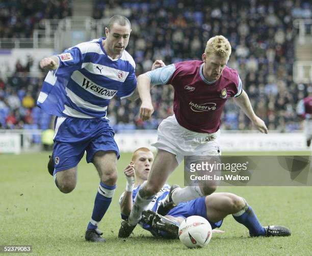 Steve Lomas of West Ham is tackled by Steve Sidwell and Andy Hughes of Reading during the Coca-Cola Championship match between Reading and West Ham...