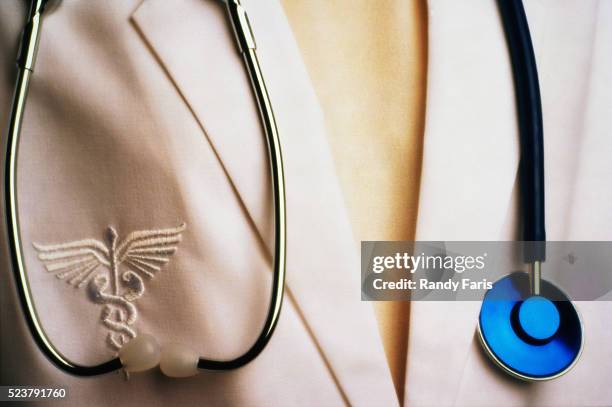 physician wearing stethoscope - medical symbol foto e immagini stock