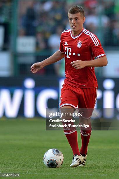 Toni Kroos of Muenchen runs with the ball during the Telekom Cup 2013 final match between Borussia Moenchengladbach and FC Bayern Muenchen at...