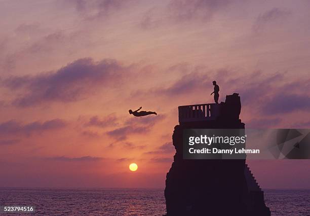 cliff divers diving in mazatlan - mexico sunset stock pictures, royalty-free photos & images