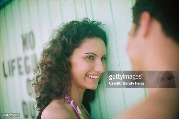 smiling woman at beach - beach hut foto e immagini stock