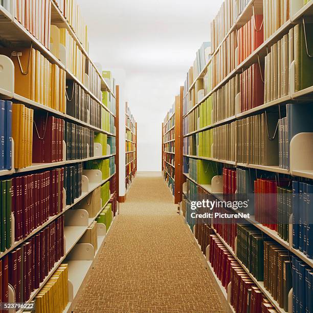 bookcases along library aisle - archival library stock pictures, royalty-free photos & images