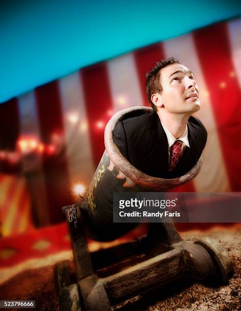 businessman being fired from cannon - kanon stockfoto's en -beelden