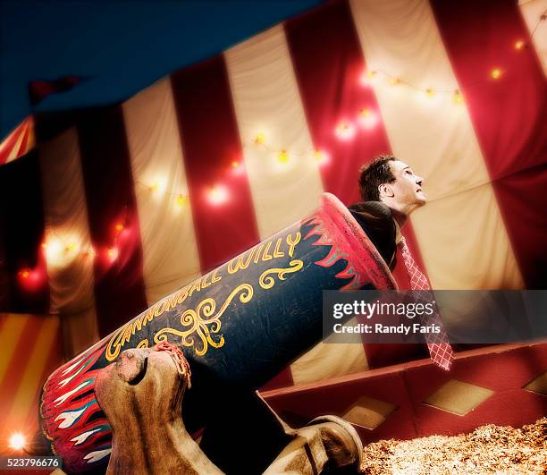 businessman being fired from cannon - circus stock-fotos und bilder