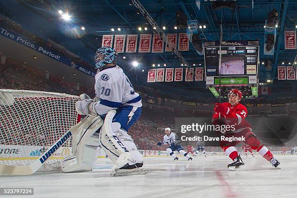 Ben Bishop of the Tampa Bay Lightning passes the puck in front of Dylan Larkin of the Detroit Red Wings in Game Four of the Eastern Conference First...