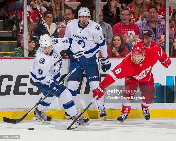 Justin Abdelkader of the Detroit Red Wings battles along the boards for the puck with Tyler Johnson and Alex Killorn of the Tampa Bay Lightning in...