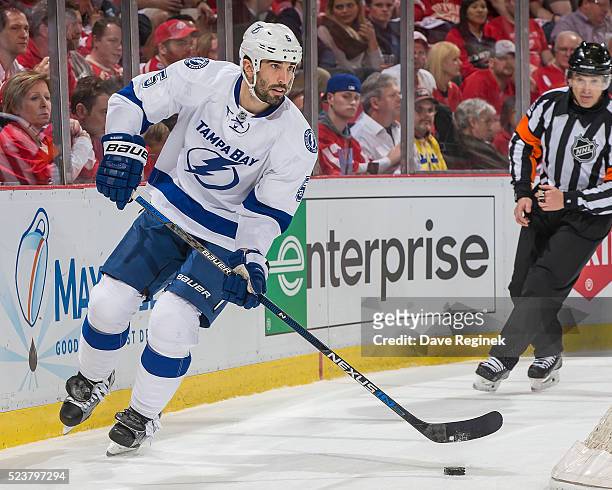 Jason Garrison of the Tampa Bay Lightning skates around the net with the puck against the Detroit Red Wings in Game Four of the Eastern Conference...