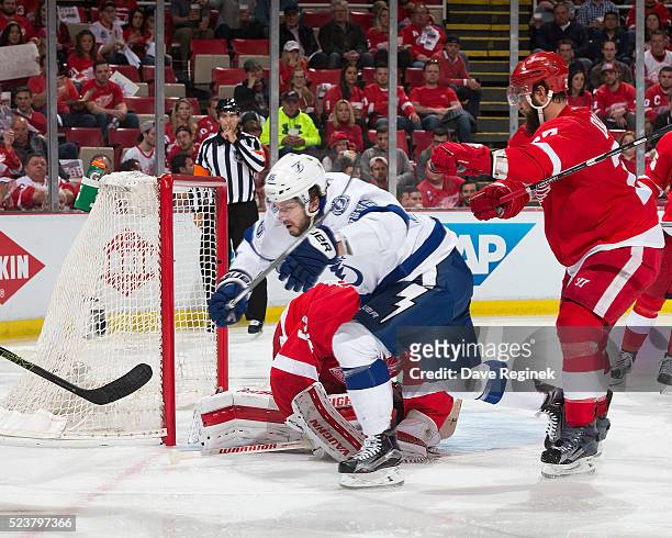 Kyle Quincey of the Detroit Red Wings pushes Nikita Kucherov of the Tampa Bay Lightning in Game Four of the Eastern Conference First Round during the...