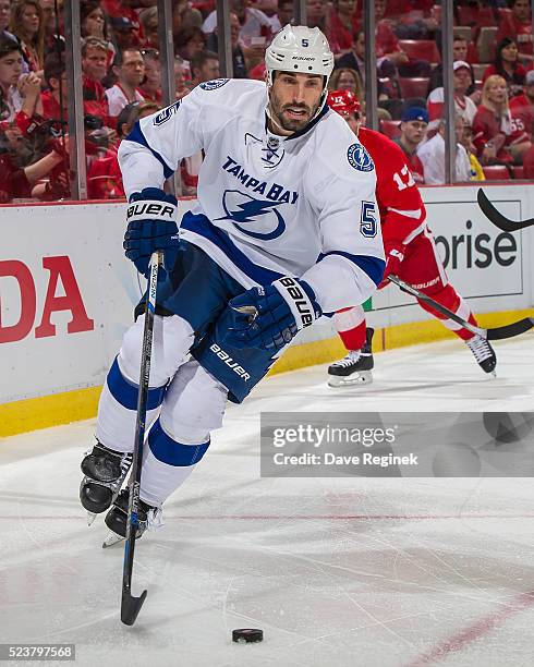 Jason Garrison of the Tampa Bay Lightning skates around the net with the puck against the Detroit Red Wings in Game Four of the Eastern Conference...