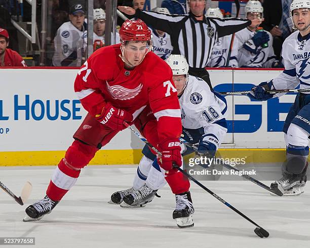 Dylan Larkin of the Detroit Red Wings skates up ice with the puck in front of Ondrej Palat of the Tampa Bay Lightning in Game Four of the Eastern...