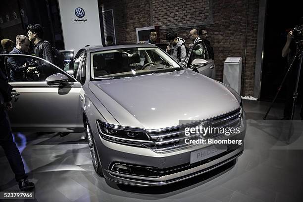 Attendees look at a SAIC-Volkswagen Phideonat at the Volkswagen Group media night event ahead of the Beijing International Automotive Exhibition in...