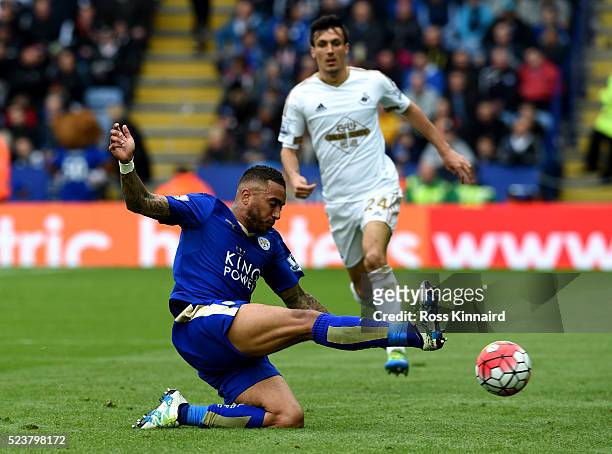 Danny Simpson of Leicester City slides to clear the ball as Jack Cork of Swansea City looks on during the Barclays Premier League match between...