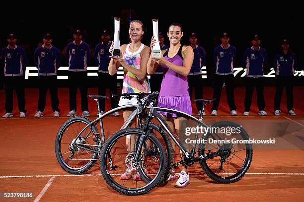 Caroline Garcia and Kristina Mladenovic of France pose with their trophies after the doubles final against Martina Hingis of Switzerland and Sania...