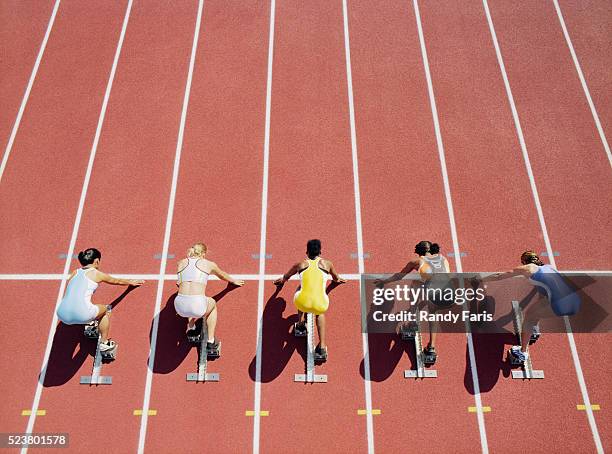 runners crouched at starting line - starting block stock pictures, royalty-free photos & images