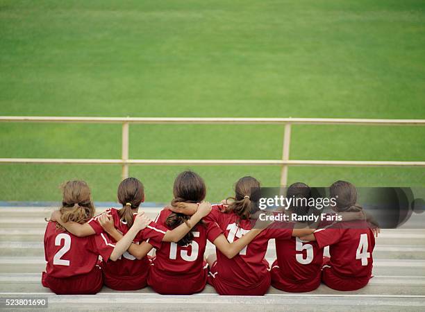 young soccer players sitting in bleachers - girl who stands stock pictures, royalty-free photos & images