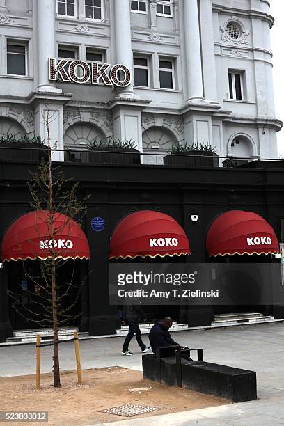 Man walks by club KOKO across from where a makeshift memorial to the musician and recording artist Prince is left beneath the Cobden statue near the...