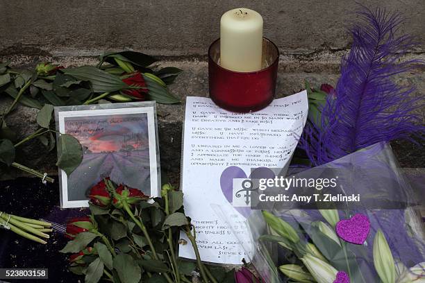 Candles, purple flowers, notes of condolences, and images of musician and recording artist Prince are left at a makeshift memorial to the artist...