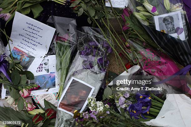 Candles, purple flowers, notes of condolences, and images of musician and recording artist Prince are left at a makeshift memorial to the artist...
