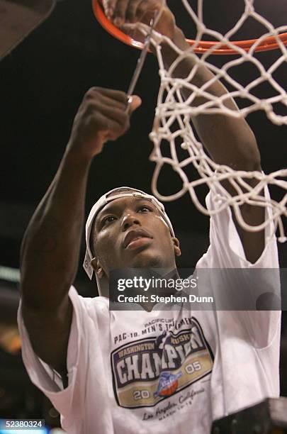 Nate Robinson of the Washington Huskies cuts down the net after winning the 2005 Pacific Life Pac-10 Men's Basketball Tournament final game against...