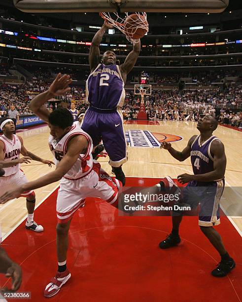 Nate Robinson of the Washington Huskies slam dunks over Channing Frye of the Arizona Wildcats during the 2005 Pacific Life Pac-10 Men's Basketball...