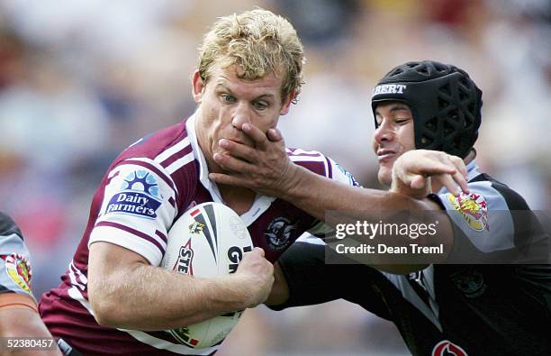 Luke Williamson of the Sea Eagles is tackled by Monty Betham of the Warriors during the Round 1 NRL match between the New Zealand Warriors and the...