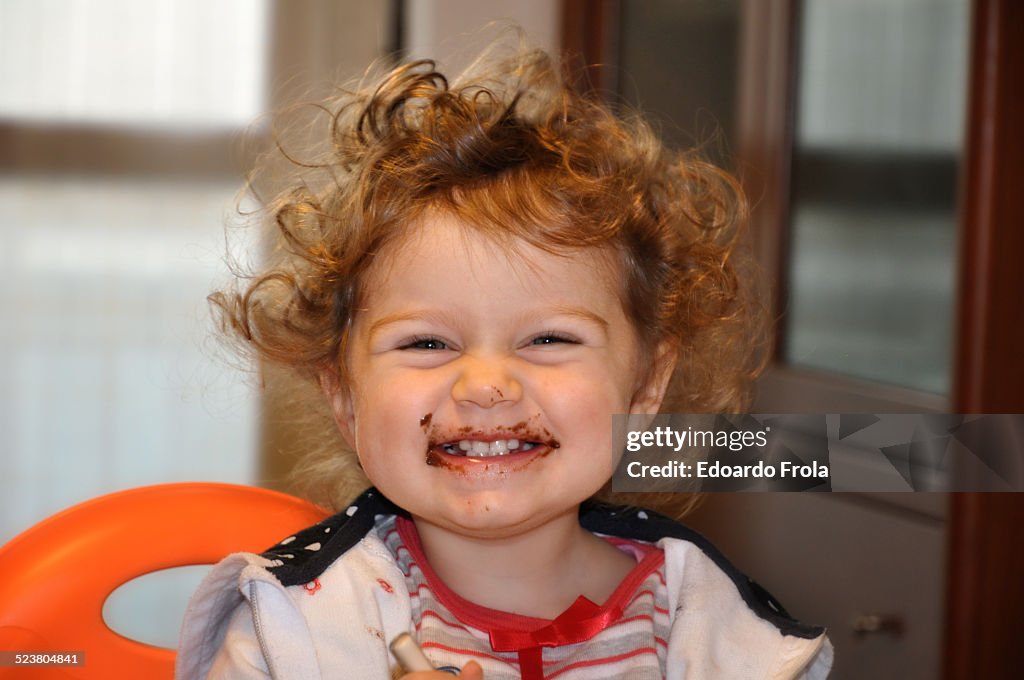 Young girl with chocolate on face