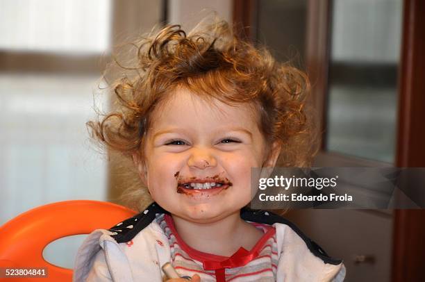 young girl with chocolate on face - mouth smirk stock pictures, royalty-free photos & images