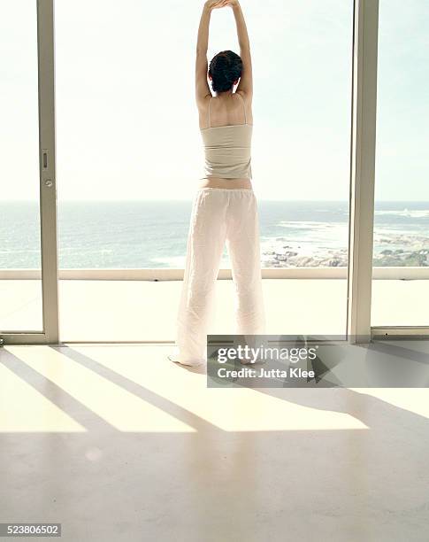 180 Stretching In Front Of Window Stock Photos, High-Res Pictures, and ...