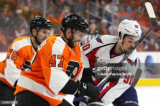 Marcus Johansson of the Washington Capitals takes a high-stick to the face from Andrew MacDonald of the Philadelphia Flyers during the first period...