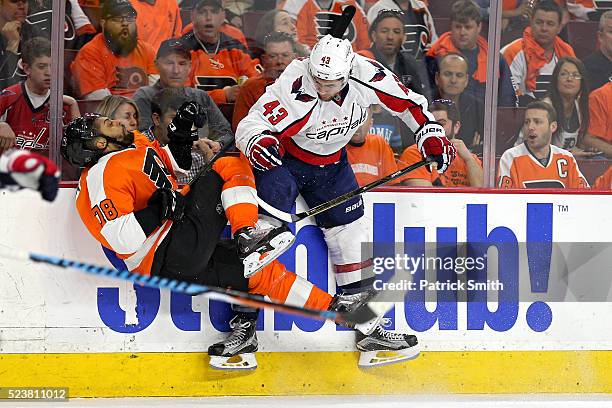 Tom Wilson of the Washington Capitals checks Pierre-Edouard Bellemare of the Philadelphia Flyers during the first period in Game Six of the Eastern...