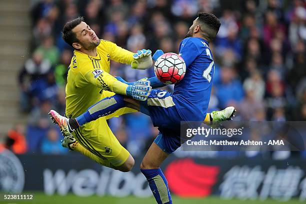 Lukasz Fabianski of Swansea City collides with Riyad Mahrez of Leicester City during the Barclays Premier League match between Leicester City and...